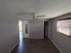 Spacious bedroom with wood-look floors, ceiling fan, and access to backyard at 3544 Wilson Dr, Holiday, FL 34691