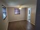 Bright bedroom with wood-look floors and ceiling fan at 3544 Wilson Dr, Holiday, FL 34691