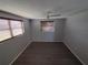 Bedroom with laminate flooring, ceiling fan, and window blinds at 3544 Wilson Dr, Holiday, FL 34691