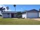 Single-story home with manicured lawn and an attached two-car garage at 3544 Wilson Dr, Holiday, FL 34691