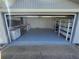Spacious garage with epoxy flooring and built-in shelving at 3544 Wilson Dr, Holiday, FL 34691