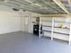 Garage with epoxy flooring and overhead storage at 3544 Wilson Dr, Holiday, FL 34691