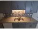 Modern kitchen with granite countertops and gray cabinets at 3544 Wilson Dr, Holiday, FL 34691