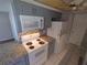 Modern kitchen with granite countertops and gray cabinets at 3544 Wilson Dr, Holiday, FL 34691