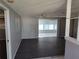 Spacious living room with dark wood floors and access to a sunroom for relaxing or entertaining at 3544 Wilson Dr, Holiday, FL 34691