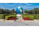 Landscaped area featuring a large globe statue as a centerpiece at 2455 Finlandia Ln # 43, Clearwater, FL 33763