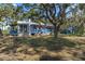 Quaint blue cottage with a screened porch and expansive yard at 8812 Camp Ln, Hudson, FL 34667