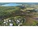 Aerial view showing home, lush landscape and waterfront access at 8812 Camp Ln, Hudson, FL 34667