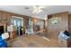 Spacious living area with wood paneling and hardwood floors at 8812 Camp Ln, Hudson, FL 34667