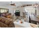 Open living room featuring a comfortable sofa and a large TV at 12233 Pitcairn St, Brooksville, FL 34613