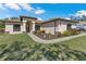 Tan house with landscaping and walkway at 12233 Pitcairn St, Brooksville, FL 34613