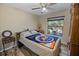 Bedroom with New York Mets comforter and ceiling fan at 12233 Pitcairn St, Brooksville, FL 34613