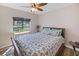 Bedroom with wooden frame bed and large window at 12233 Pitcairn St, Brooksville, FL 34613