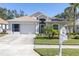 Charming one-story home with a two-car garage and well-manicured lawn at 13215 Golf Ridge Pl, Hudson, FL 34669