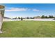 Large fenced backyard with grassy lawn at 647 Wilsford Ln, Spring Hill, FL 34609