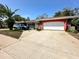 Ranch style home with a brick facade and attached garage at 8111 Roxboro Dr, Hudson, FL 34667