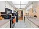 Galley kitchen with black appliances and ample counter space at 11010 Rollingwood Dr, Port Richey, FL 34668