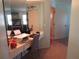 Home office with built-in desk and mirror at 3968 Sailmaker Ln # 3968, Holiday, FL 34691