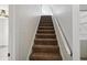 Carpeted staircase leading to the upper level of the home at 2216 Waterfall Dr, Spring Hill, FL 34608