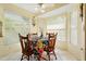 Charming breakfast nook with floral tablecloth and wooden chairs at 2421 Rolling View Dr, Spring Hill, FL 34606