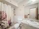 Cozy bathroom with shower and tub combination, decorative tile, and vanity at 10824 Peppertree Ln, Port Richey, FL 34668
