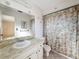 Bathroom featuring a large mirror, decorative tile, shower, and vanity at 10824 Peppertree Ln, Port Richey, FL 34668