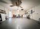 Spacious garage with ceiling fan, washer and dryer, with room for multiple cars at 10824 Peppertree Ln, Port Richey, FL 34668