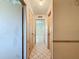 Hallway with tile floors, neutral walls, and access to multiple rooms at 10824 Peppertree Ln, Port Richey, FL 34668