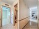 Bright hallway features tile floors and neutral walls leading to other rooms in the home at 10824 Peppertree Ln, Port Richey, FL 34668