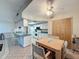 Open concept kitchen area with light cabinets, tile flooring, and a dining area at 10824 Peppertree Ln, Port Richey, FL 34668