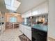 Open concept kitchen with island, stainless steel sink, and black dishwasher at 10824 Peppertree Ln, Port Richey, FL 34668