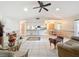 Open living space with tile floors connects to kitchen and dining areas at 10824 Peppertree Ln, Port Richey, FL 34668