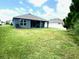 A lush, green lawn is the focal point of this home's backyard at 13447 Newport Shores Dr, Hudson, FL 34669