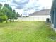 A large backyard with a privacy fence and mature trees offers a serene retreat at 13447 Newport Shores Dr, Hudson, FL 34669