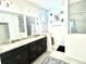 Bright bathroom featuring a double vanity with granite countertops and tiled shower at 13447 Newport Shores Dr, Hudson, FL 34669
