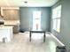 Dining area adjacent to the kitchen features large windows and neutral walls at 13447 Newport Shores Dr, Hudson, FL 34669