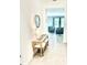 A charming foyer featuring a console table with seating and decorative mirror at 13447 Newport Shores Dr, Hudson, FL 34669