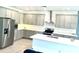 Bright kitchen features stainless steel appliances and a central island at 13447 Newport Shores Dr, Hudson, FL 34669