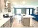 Open floor plan featuring the kitchen and dining areas with modern gray cabinetry at 13447 Newport Shores Dr, Hudson, FL 34669