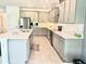 Bright kitchen features stainless steel appliances, a central island, and sleek finishes at 13447 Newport Shores Dr, Hudson, FL 34669