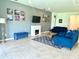 Comfortable living room features gray walls, decor, and a modern fireplace at 13447 Newport Shores Dr, Hudson, FL 34669