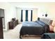 Comfortable main bedroom featuring large windows, a dresser and a plush bed at 13447 Newport Shores Dr, Hudson, FL 34669
