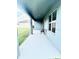 View of a covered patio with an outside chair for relaxation at 13447 Newport Shores Dr, Hudson, FL 34669