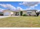 Ranch-style home with attached garage and well-maintained lawn at 1542 Derrick St, Holiday, FL 34690