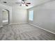 Large living room featuring neutral decor and carpeting at 3323 Golden Eagle Dr, Land O Lakes, FL 34639