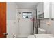 Clean bathroom with shower, toilet, and storage at 3423 Umber Rd, Holiday, FL 34691