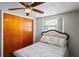 Bedroom with wood sliding doors and a ceiling fan at 3423 Umber Rd, Holiday, FL 34691