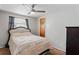 Comfortable bedroom with a ceiling fan and striped bedding at 3423 Umber Rd, Holiday, FL 34691