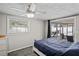 Cozy bedroom featuring a ceiling fan and backyard access at 3423 Umber Rd, Holiday, FL 34691