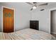 Bedroom with striped bedspread, dresser, and ceiling fan at 3423 Umber Rd, Holiday, FL 34691